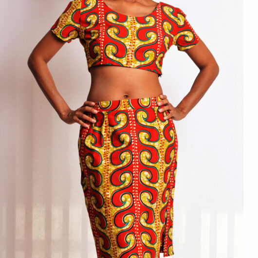 model wearing brown african print short sleeve crop top and straight skirt