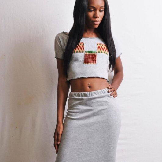 model wearing grey jersey knit crop top and straight skirt set