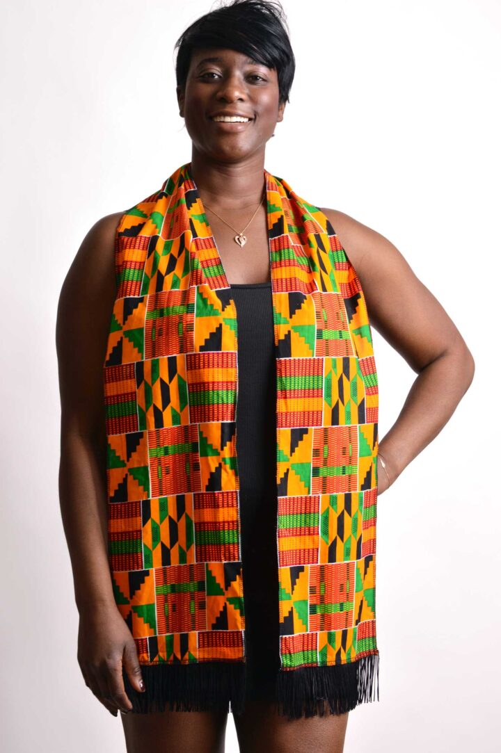 woman proudly wearing african kente scarf smiling