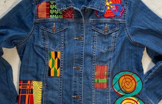 close up denim jacket with african print patches