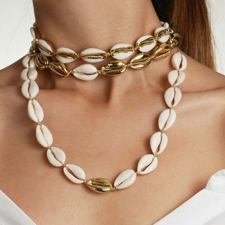 natural cowrie shell choker necklace with one gold shell in the middle