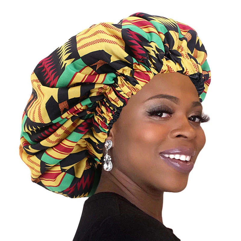 woman wearing an african print satin lined bonnet night sleep cap with wide band